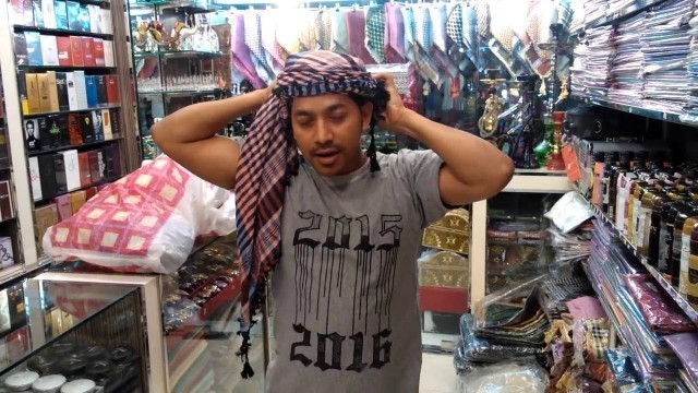 'Tying a head scarf - Omani style'